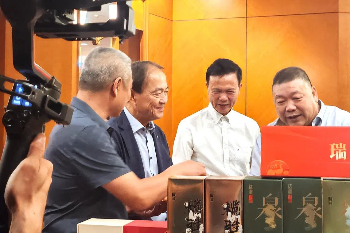 潮州总会会长张建安（右二）和秘书长林惠海（左二）参观潮州地道美食小吃文化展。（陈爱薇摄）
