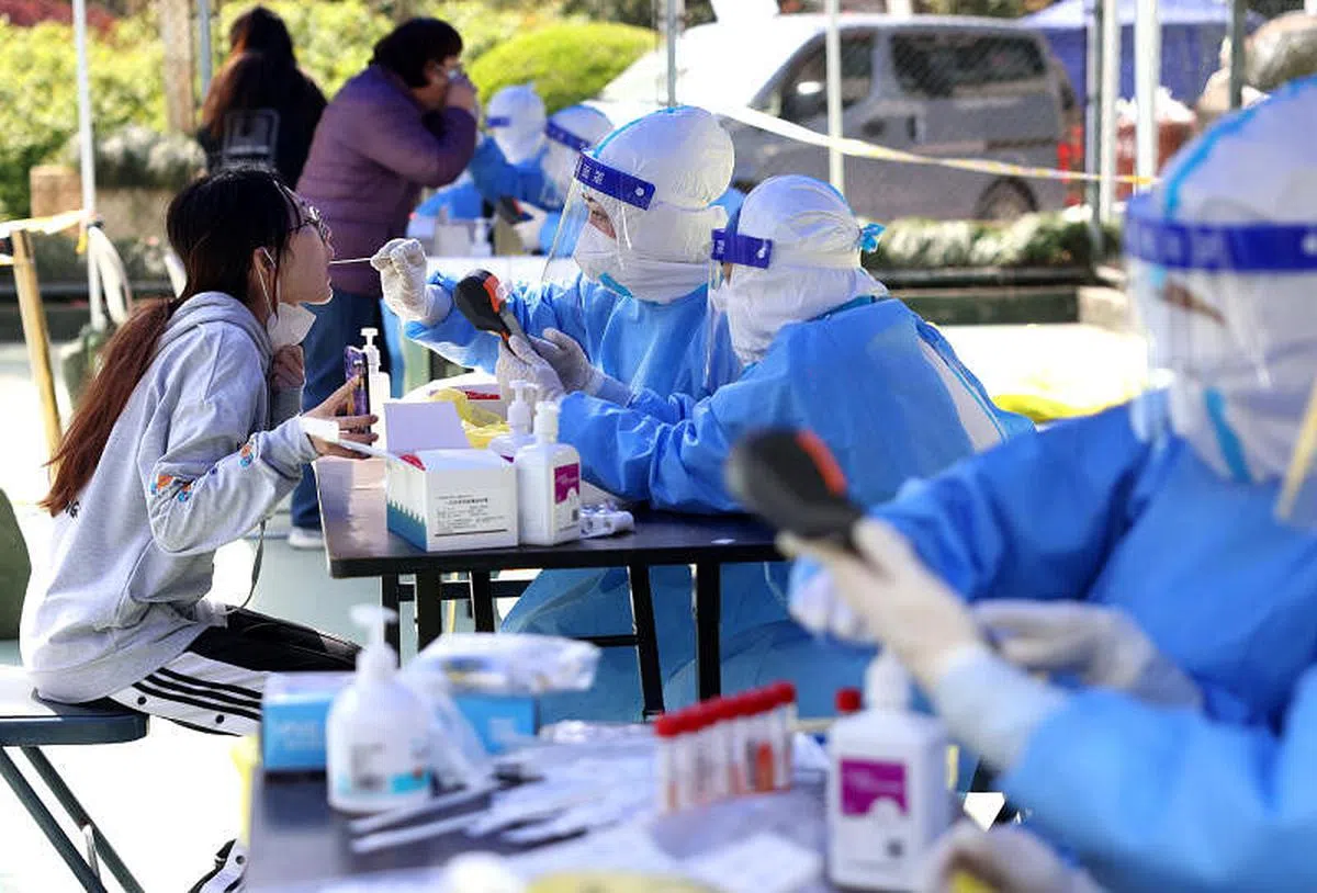 4月6日，医务人员在上海市普陀区长风新村街道为居民进行核酸检测采样。（新华社）