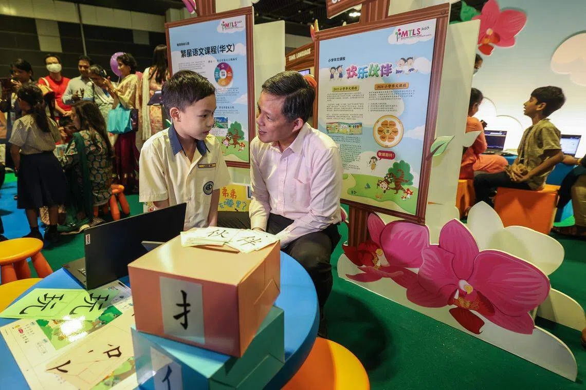 陈振声（中）呼吁家长，在家打造讲母语的环境，陪孩子一起阅读，有意识地为孩子打好母语基础。（白艳琳摄）