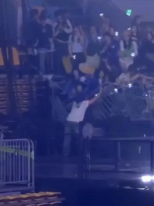 看台的临时栏杆受到挤压而断裂，导致三名粉丝坠落后受伤。（视频截图）