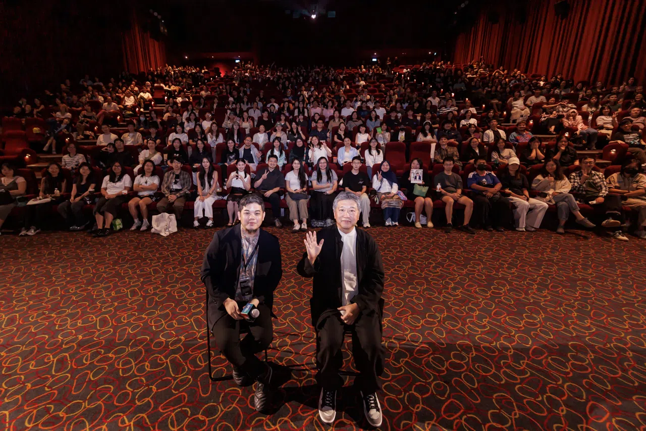 是枝裕和（前排右）在《蓦然回首》放映会上，与新加坡观众合照。前排左为SGIFF节目总监童祈为。（新加坡国际电影节提供）