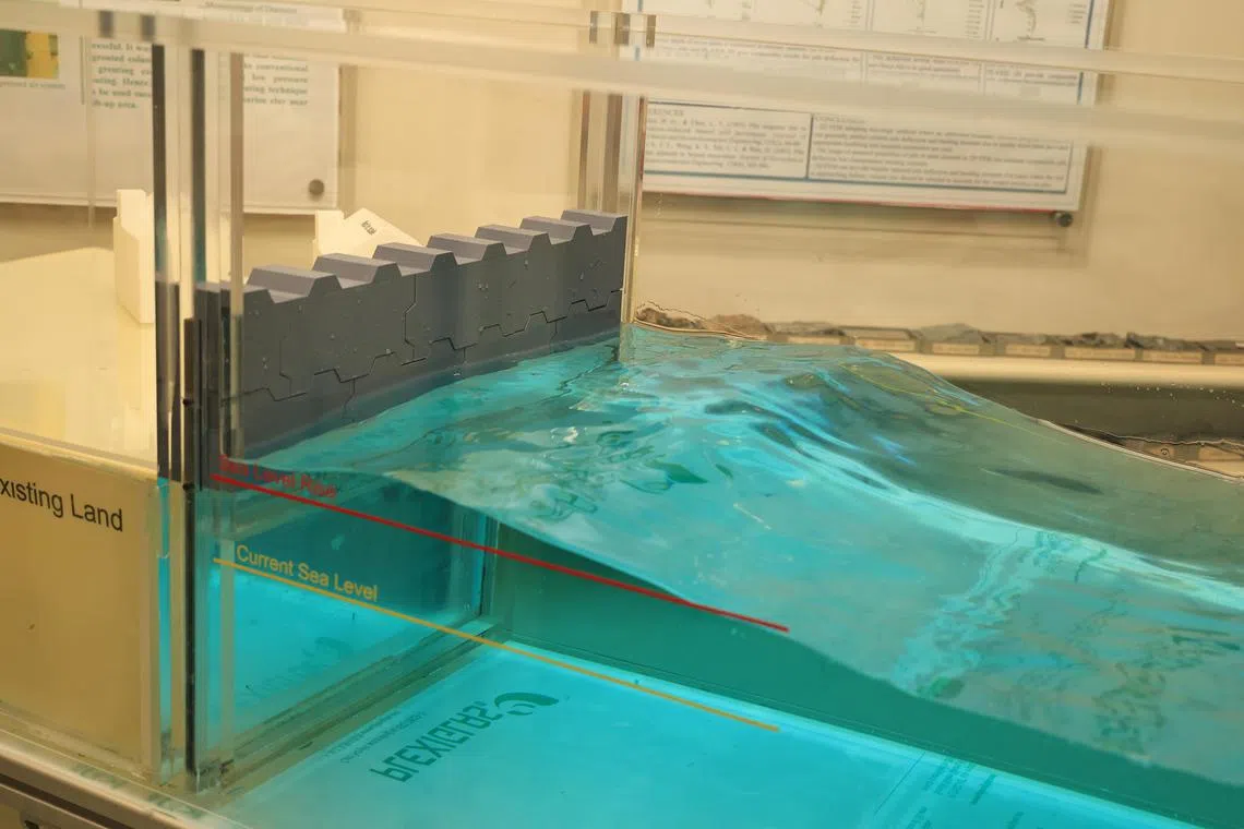 研究团队在实验室中，模拟海平面上升可能带来的威胁，并评估防波堤经加固后能否有效防止海水倒灌。（周国威摄）