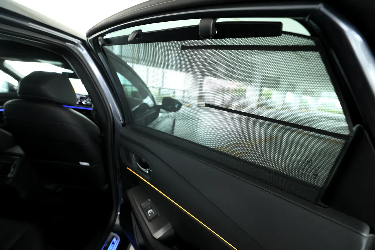 后座车窗配备遮阳帘，能减少阳光直射，提升乘坐舒适度。（龙国雄摄）