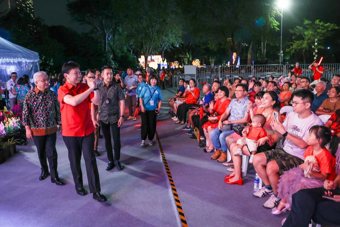 交通部长兼财政部第二部长徐芳达（左二）大年初一，作为活动主宾参与春到河畔，与在场公众打招呼。（白艳琳摄）