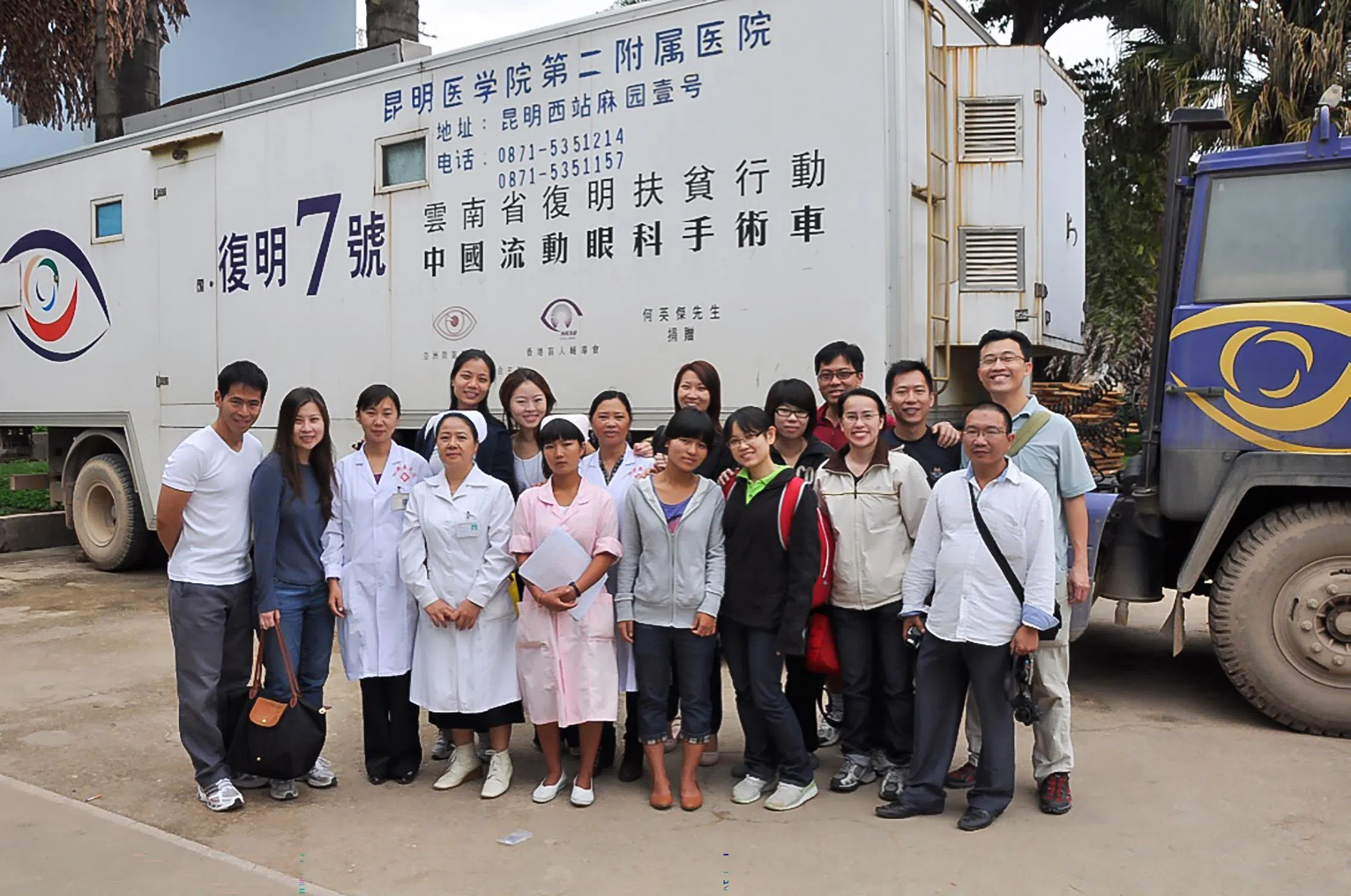 伦承志医生（后排右一）在国外义诊，指导云南流动眼科手术车医疗团队。（受访者提供）