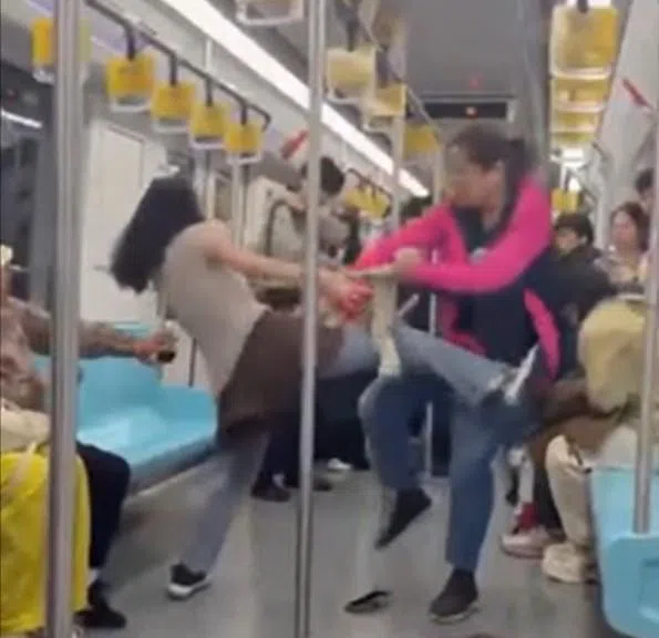 上海地铁一号线上个星期六（25日）下午发生乘客互殴事件。一名32岁女子与一名66岁老妇，因争抢座位在车厢内大打出手，互扯头发，过程被其他乘客拍下。（视频截图）
