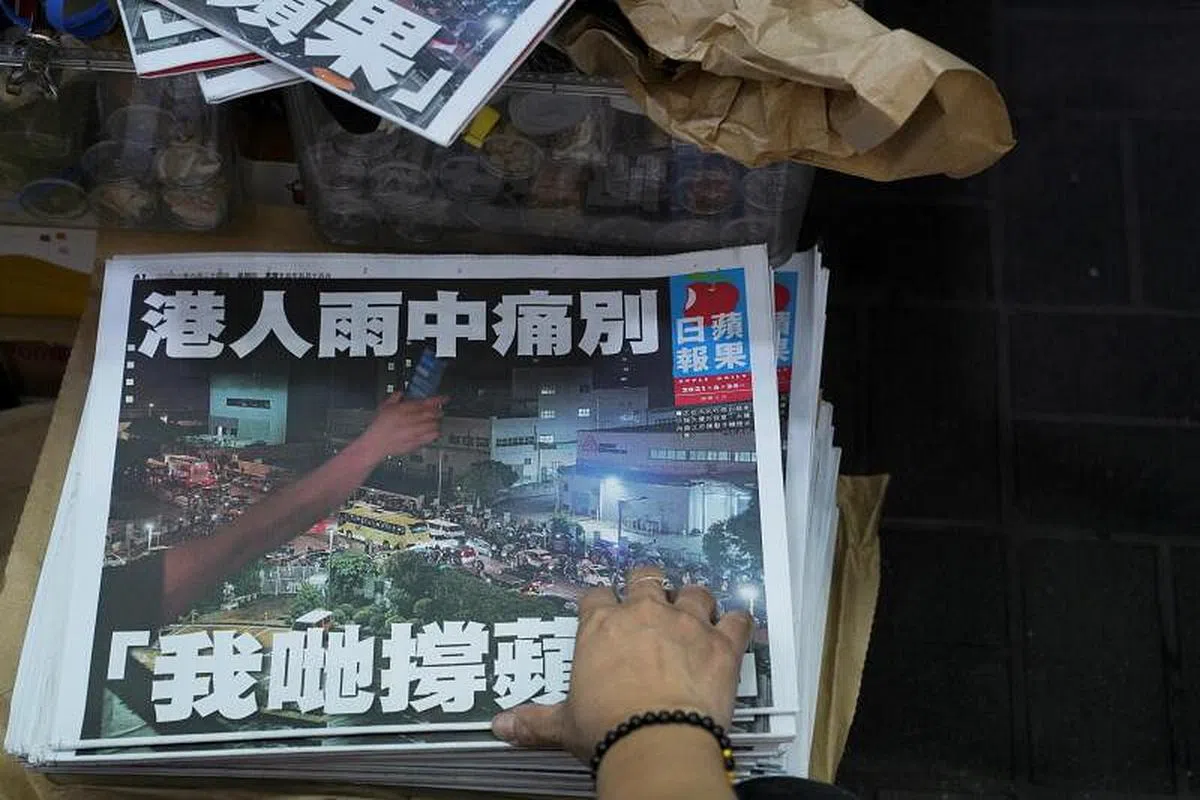 图为《苹果日报》最后一期的封面，并以“港人雨中痛别 我哋（我们）撑苹果”为题。（路透社）