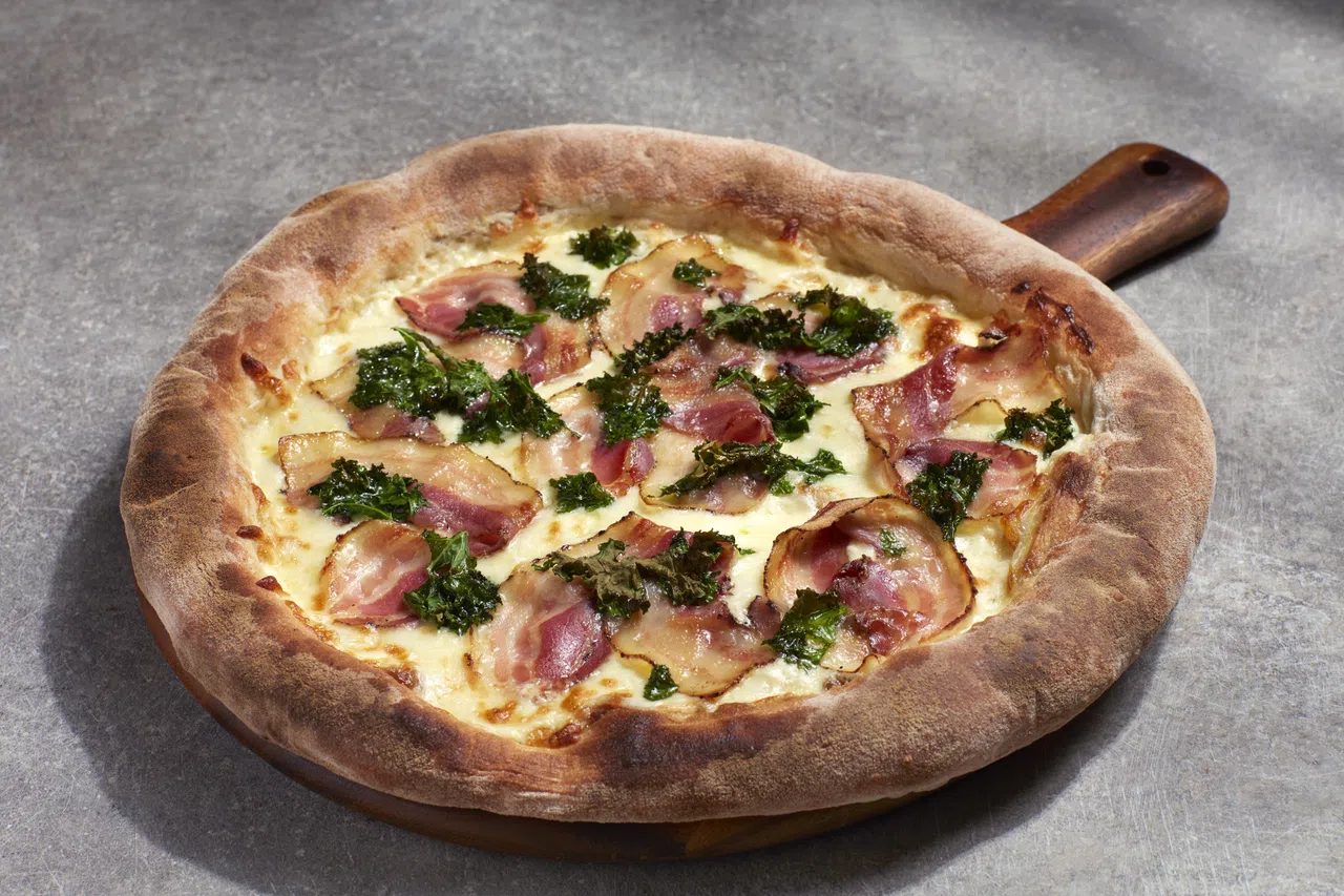 Pura Brasa新推出的意大利腌制猪五花和羽衣甘蓝比萨。（餐馆提供）