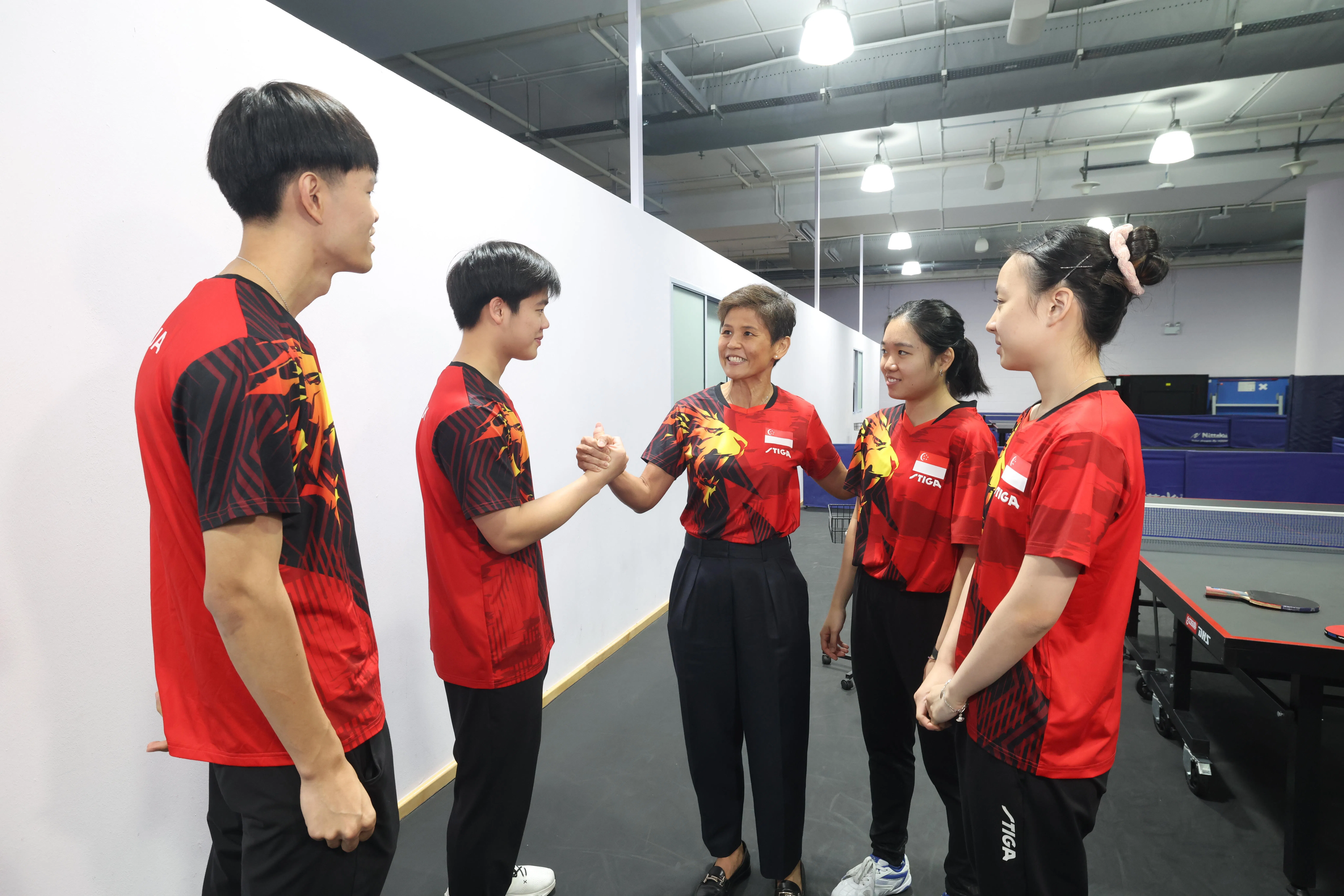 乒总会长傅丽珊（中）勉励郭勇（左二）在内的球员们，在日本亚运会赛出风采。（郑一鸣摄）