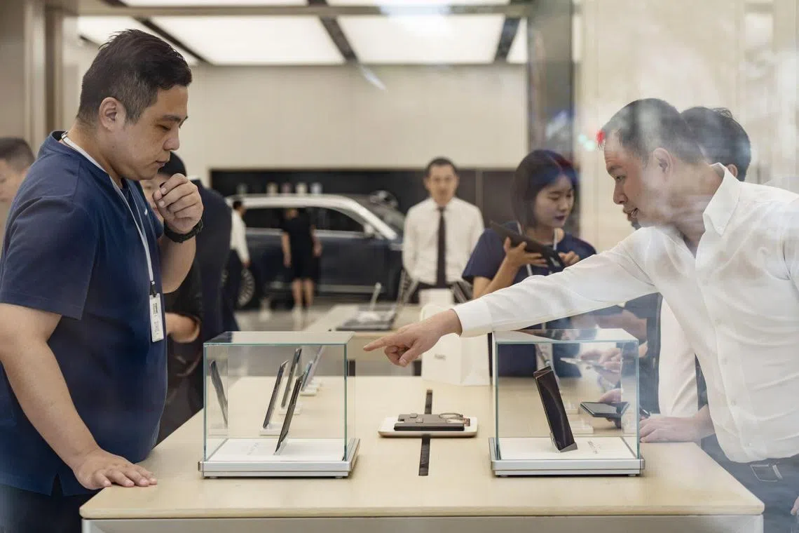 华为首款三折叠屏手机Mate XT非凡大师一经上市瞬间秒空。图为华为位于上海一家门店内。（彭博社）