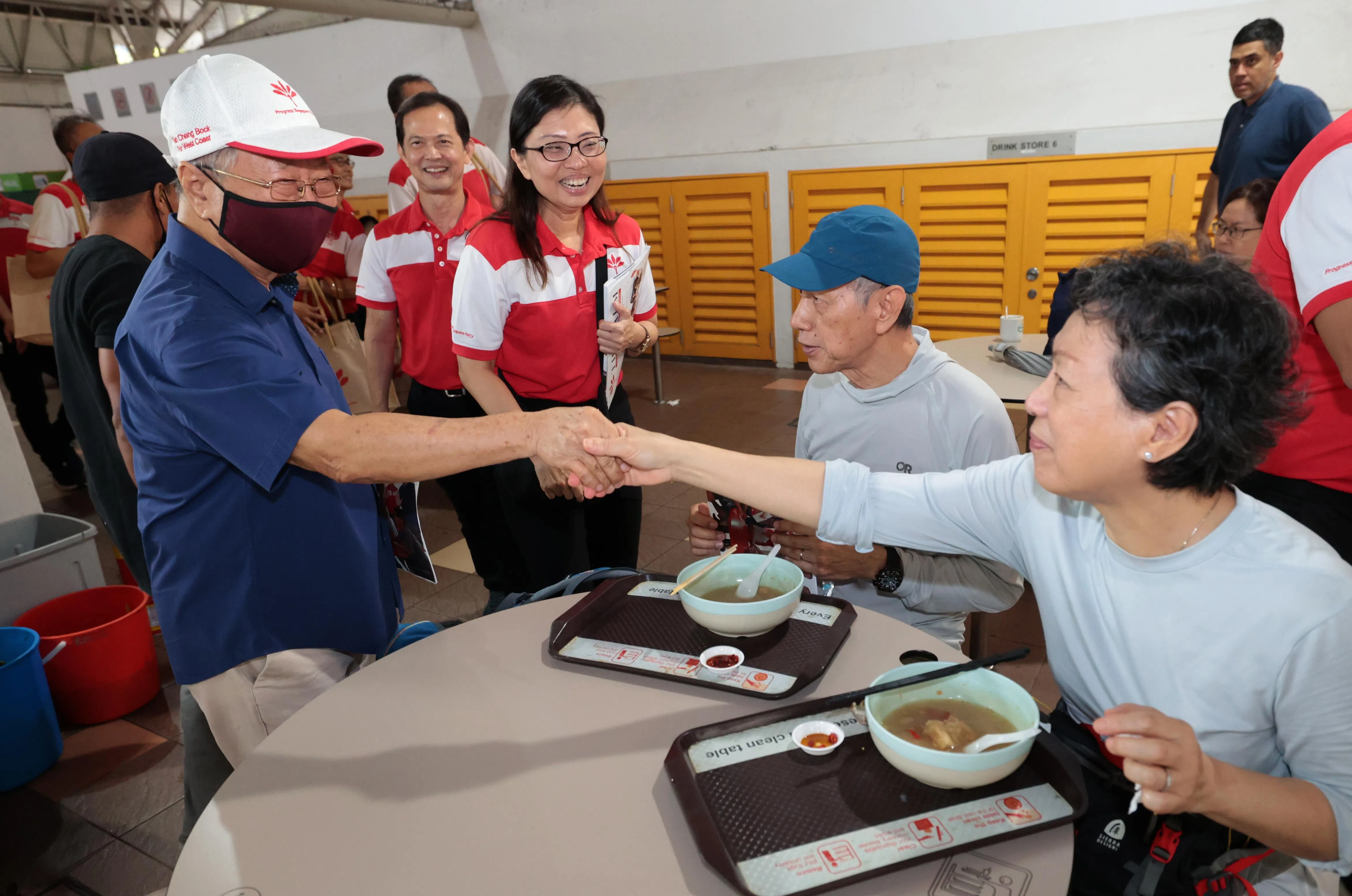 过去几年，新加坡前进党继续在西海岸集选区走动，6月初在德曼花园熟食中心走访的包括2020年大选曾竞逐该区议席的前进党秘书长潘群勤（中）、官委议员梁文辉（左二），以及前进党主席陈清木医生（左一）。（梁麒麟摄）