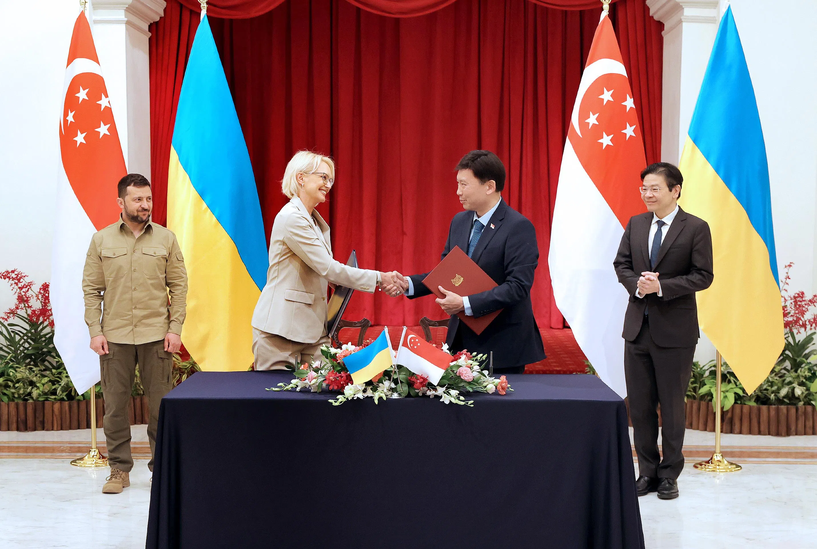我国总理黄循财（右一）与乌克兰总统泽连斯基（左一）见证由我国交通部长兼财政部第二部长徐芳达（右二），以及乌克兰驻新加坡大使泽连科（左二）签署的航空服务协议。（通讯及新闻部提供）