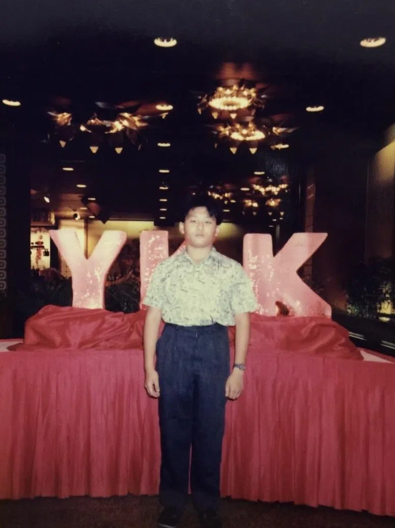 新兴泉记从1976年起是全球领先拉链制造商YKK在新加坡的总代理，黄泉铵自小对拉链很感兴趣，一“玩”就是30多年，是业内公认的“拉链王子”。图为还在小学的黄泉铵，参与YKK一场周年晚宴。（受访者提供）