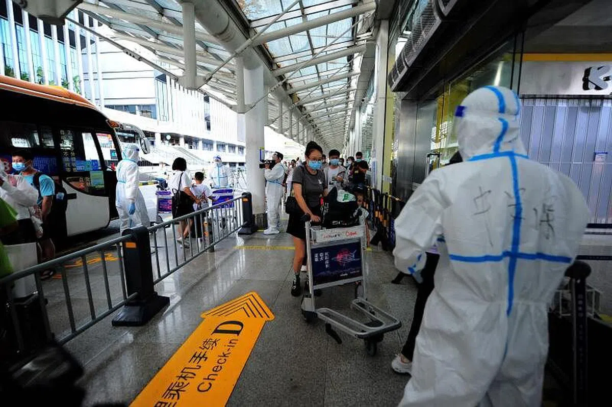 海南官方决定从星期二起，分类分批安排符合条件的滞留旅客返程。图为旅客星期二在三亚凤凰国际机场办理离境手续。（法新社） 