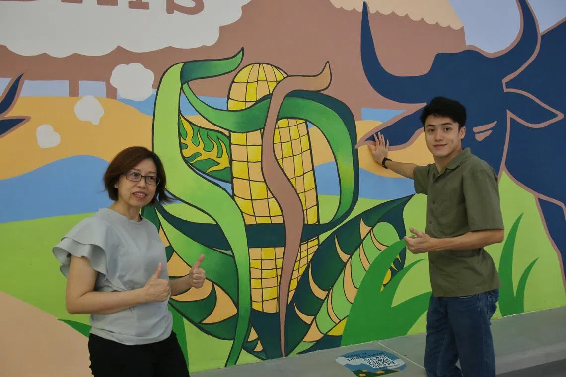 特需艺术家陈睿恩（右）参与了壁画的设计和构思，他的母亲兼主要看护人朱丽蓉全程陪伴，两人还参与其中，为陈睿恩设计的玉蜀黍图案上色。（特约陈福洲摄）
