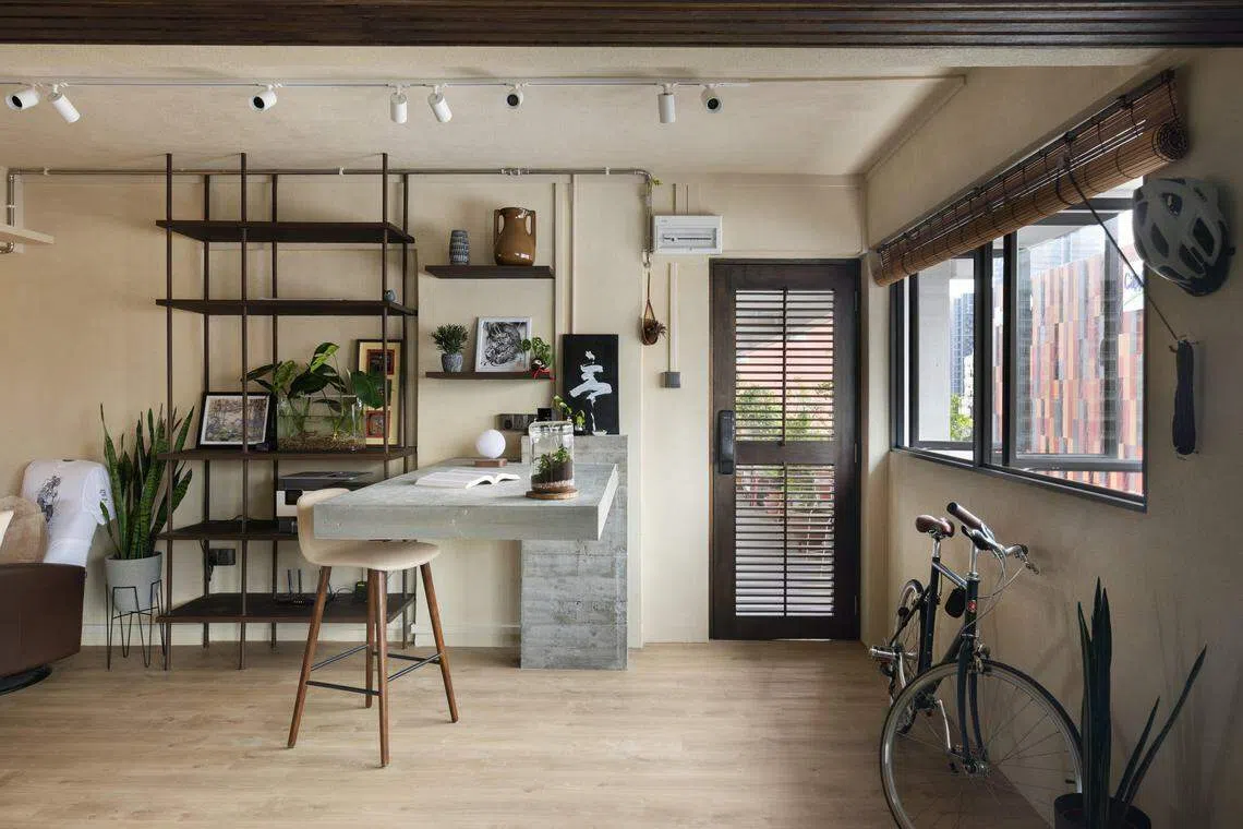 定制的悬臂式钢筋混凝土工作台，就在入门处，看起来像漂浮在水面上。（PI Architects）