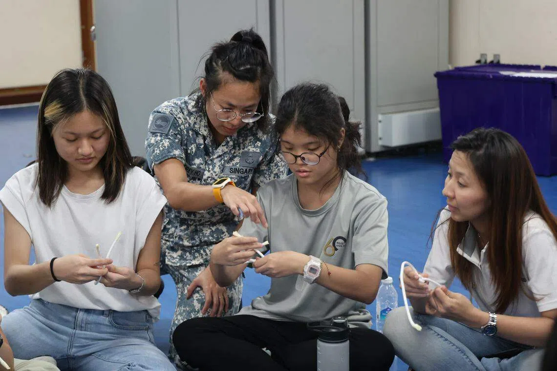 海军人员在活动中教导参与者各种绳结技能。（唐家鸿摄）