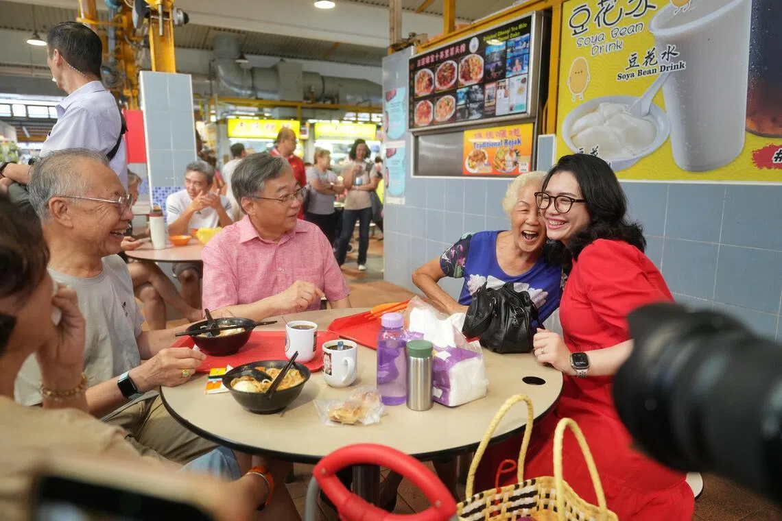 副总理兼贸工部长颜金勇（左二）星期天在凤山小贩中心与居民互动。右一为负责凤山区事务的东海岸集选区议员何礼娜。（谢智扬摄）