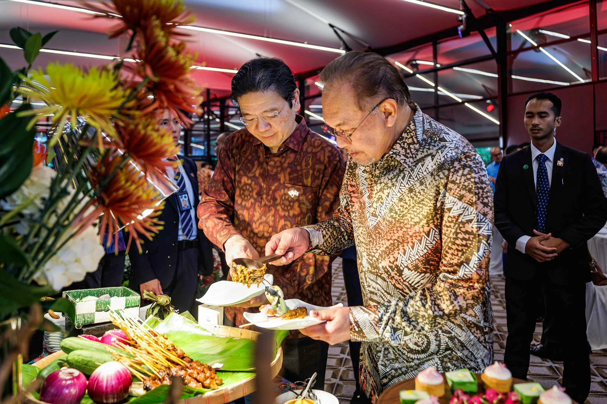 黄循财总理（左）和马来西亚首相安华（右）12月4日在新马领导人非正式峰会期间，共进下午茶。两人互动友好，黄总理也给安华夹菜。（黄循财总理脸书）