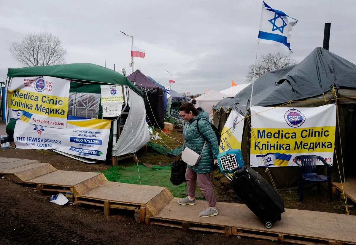 世界卫生组织正在协调波兰在医疗保健和精神保健的“小组”，以防止对接收国造成不必要的压力。（路透社）