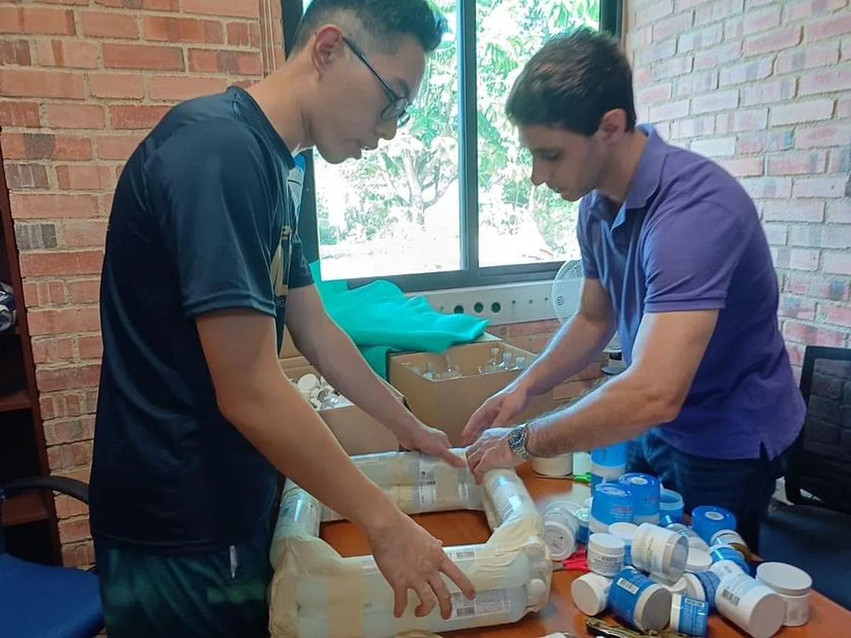 过去数个月，团队不断尝试制作漂浮菜园的模型，包括以纸胶带绑住公众捐出的护肤品空瓶。图中团员为王国聪（左）和贝正旭博士。（受访者提供）