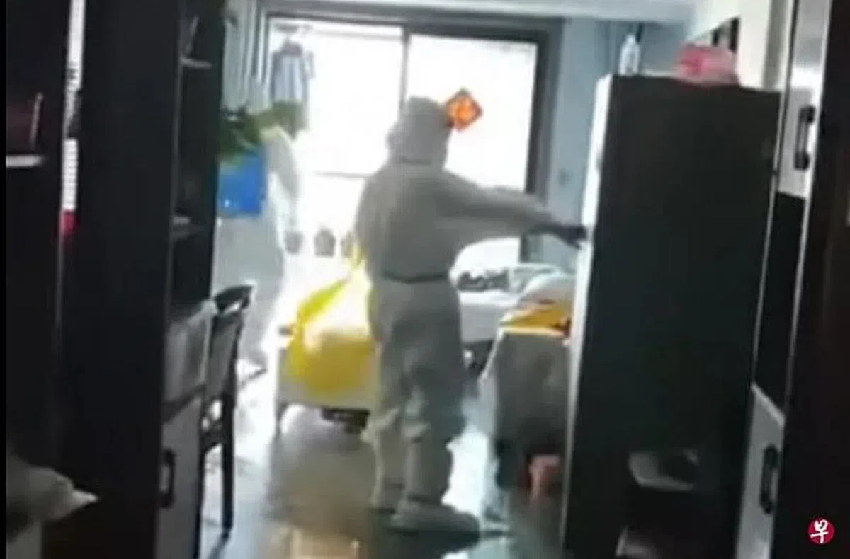 今年5月在网上热传的一段视频显示，江苏徐州一居所被入户消杀，两三个大白对着打开的冰箱、地板、电视、沙发上喷大量消毒剂。（视频截图）