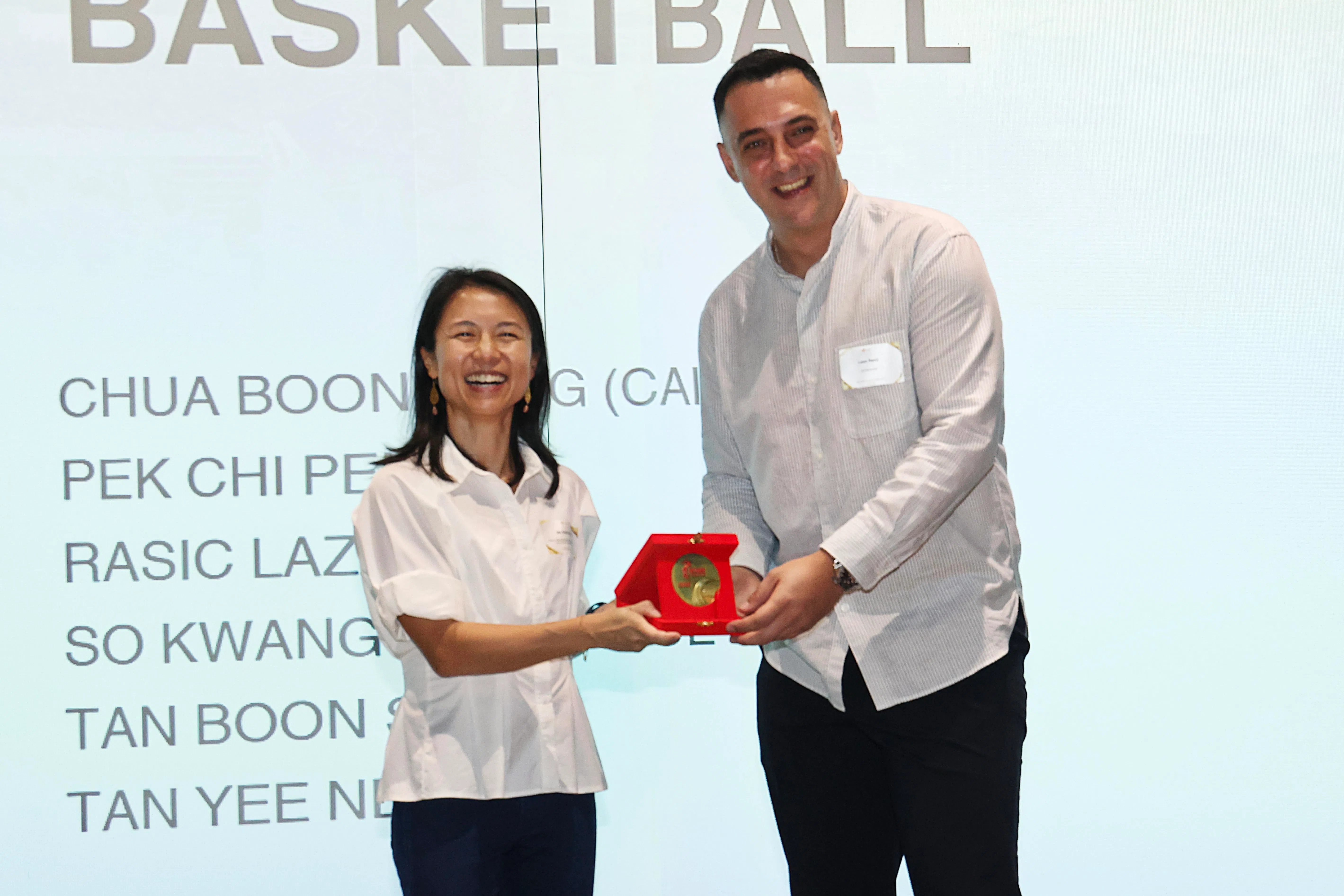 塞尔维亚籍三人篮球教练拉西奇（右）从文化、社区及青年部兼永续发展与环境部高级政务次长吴函燕（左）手中接过奖章。这是拉西奇首次获得该奖项。（郑一鸣摄）