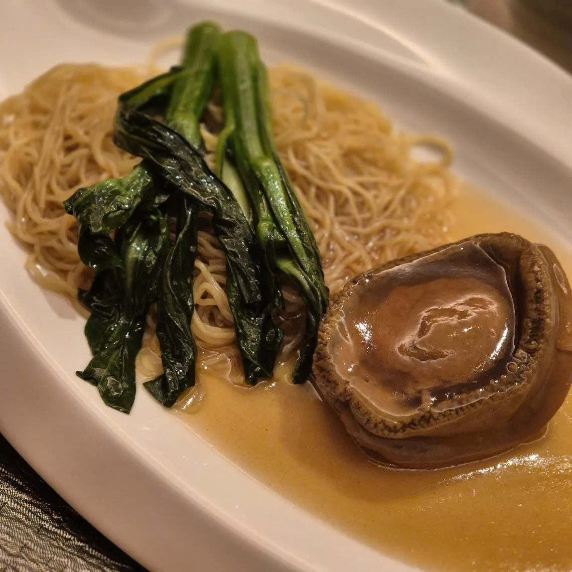 “宴”餐馆的蚝皇南非吉品鲜鲍伴生面。（陈爱薇摄）