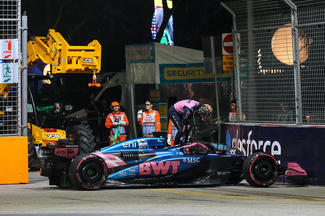 阿尔卑的加斯利（粉衣）的赛车在排位赛中出现故障，只能停在赛道边退赛，无奈垫底。但因为两辆威廉姆斯因尾翼违规未能通过检测，排位赛成绩取消将在正赛从最后一排发车，加斯利也提升到了第18名发车。（张俊杰摄）