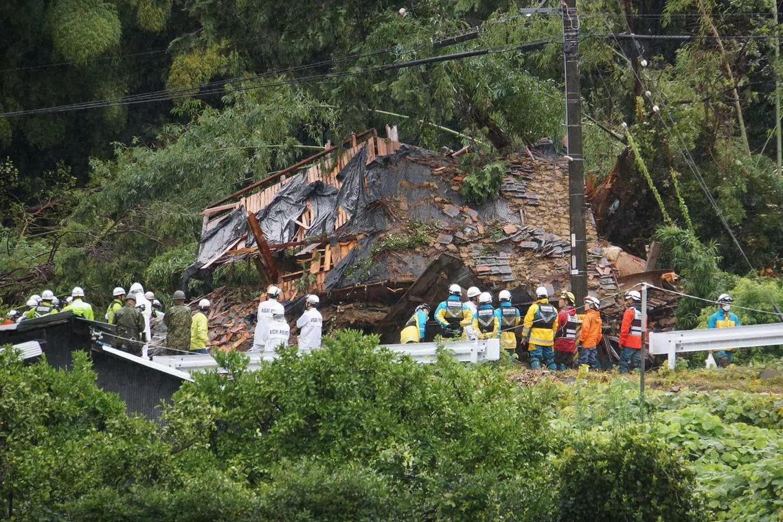 8月28日，爱知县蒲郡市一处倾泻的山泥掩埋一栋房屋，救援人员救出的屋内一家五口当中，二男一女死亡。（法新社）