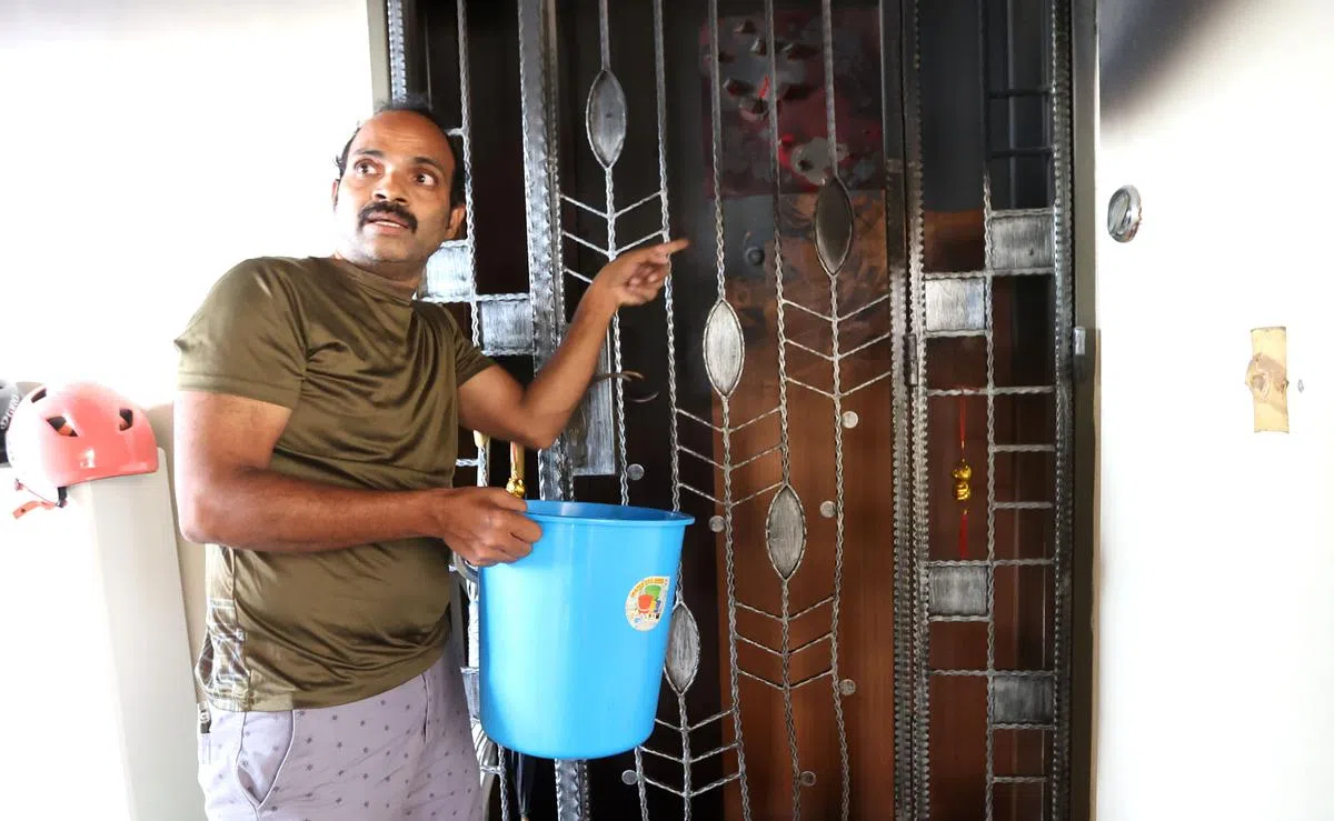 协助灭火的邻居森迪向记者讲述当时的救火情况。（庄耿闻摄）