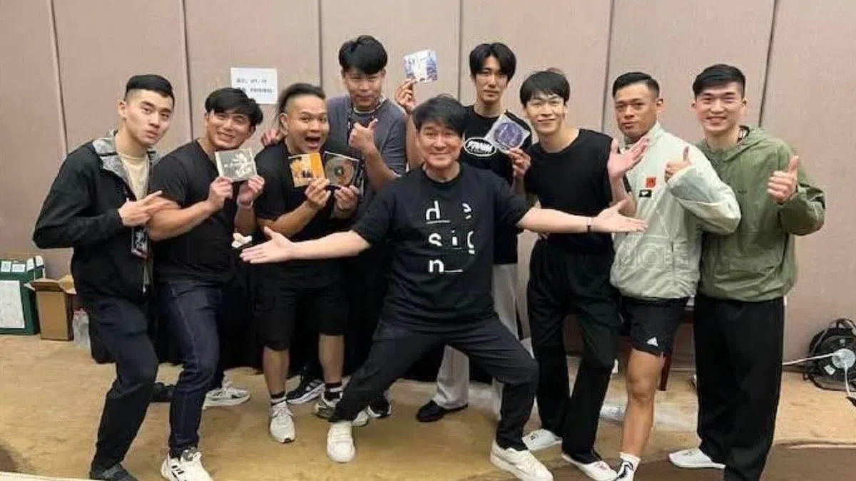 周华健（中间伸展手臂者）亲切与粉丝合照。（互联网）