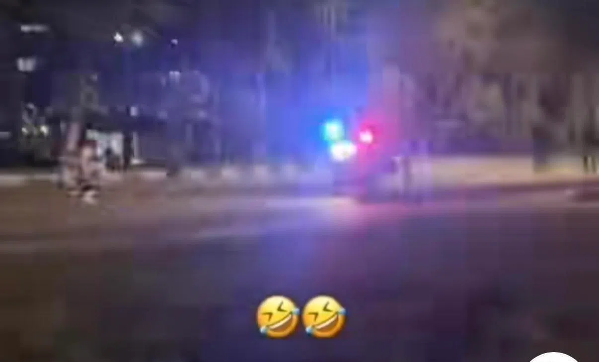两三名执法人员骑着电单车，鸣笛并闪起红蓝警示灯，示意这群少年停下受查。（取自TikTok）