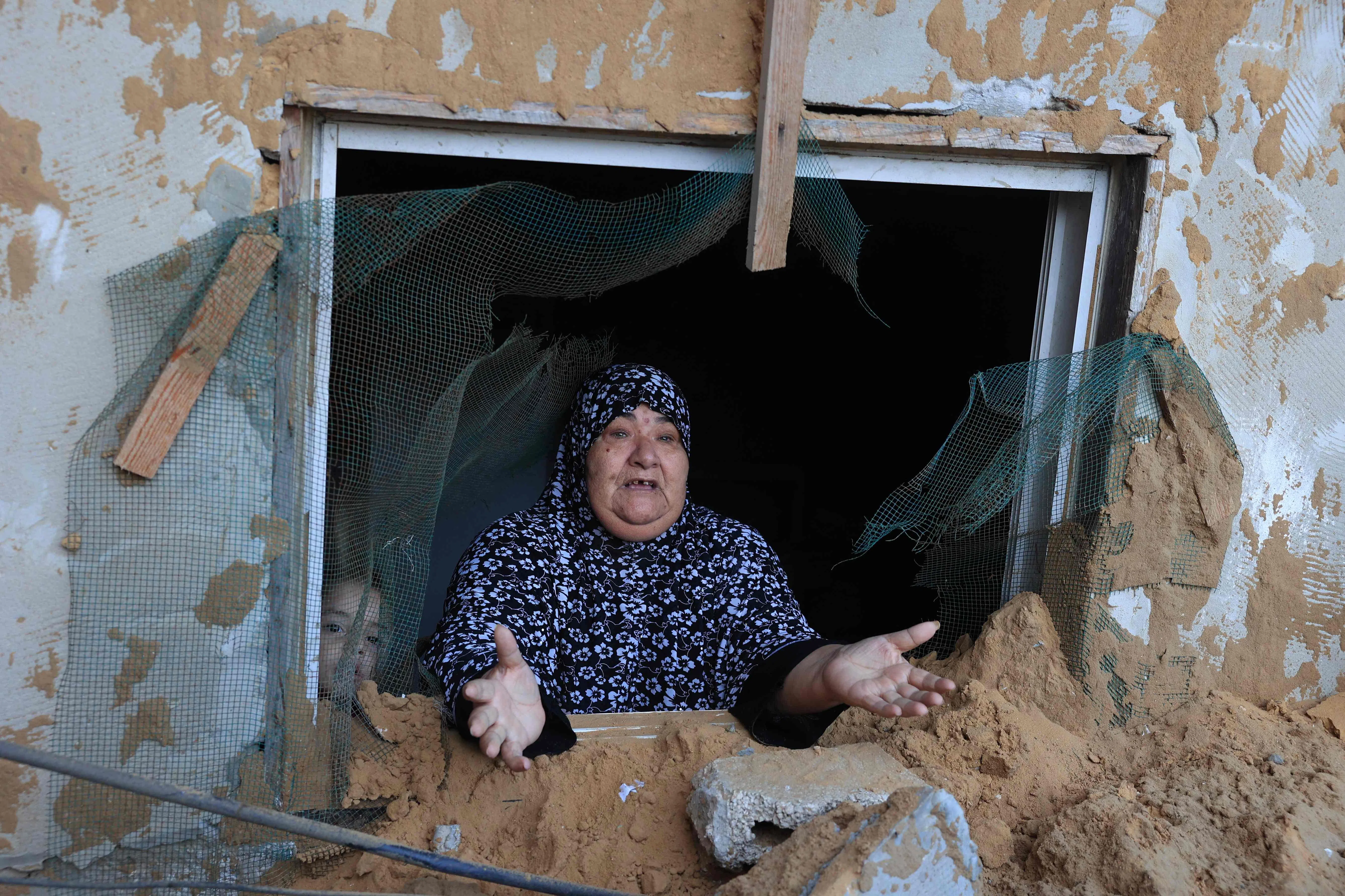 10月15日，以色列的导弹击中加沙南部拉法市（Rafah）一个难民营，侥幸逃过一劫的巴勒斯坦妇女一脸无奈。尽管巴勒斯坦人从加沙北部逃到南部，但南部地区也未必安全。（法新社）