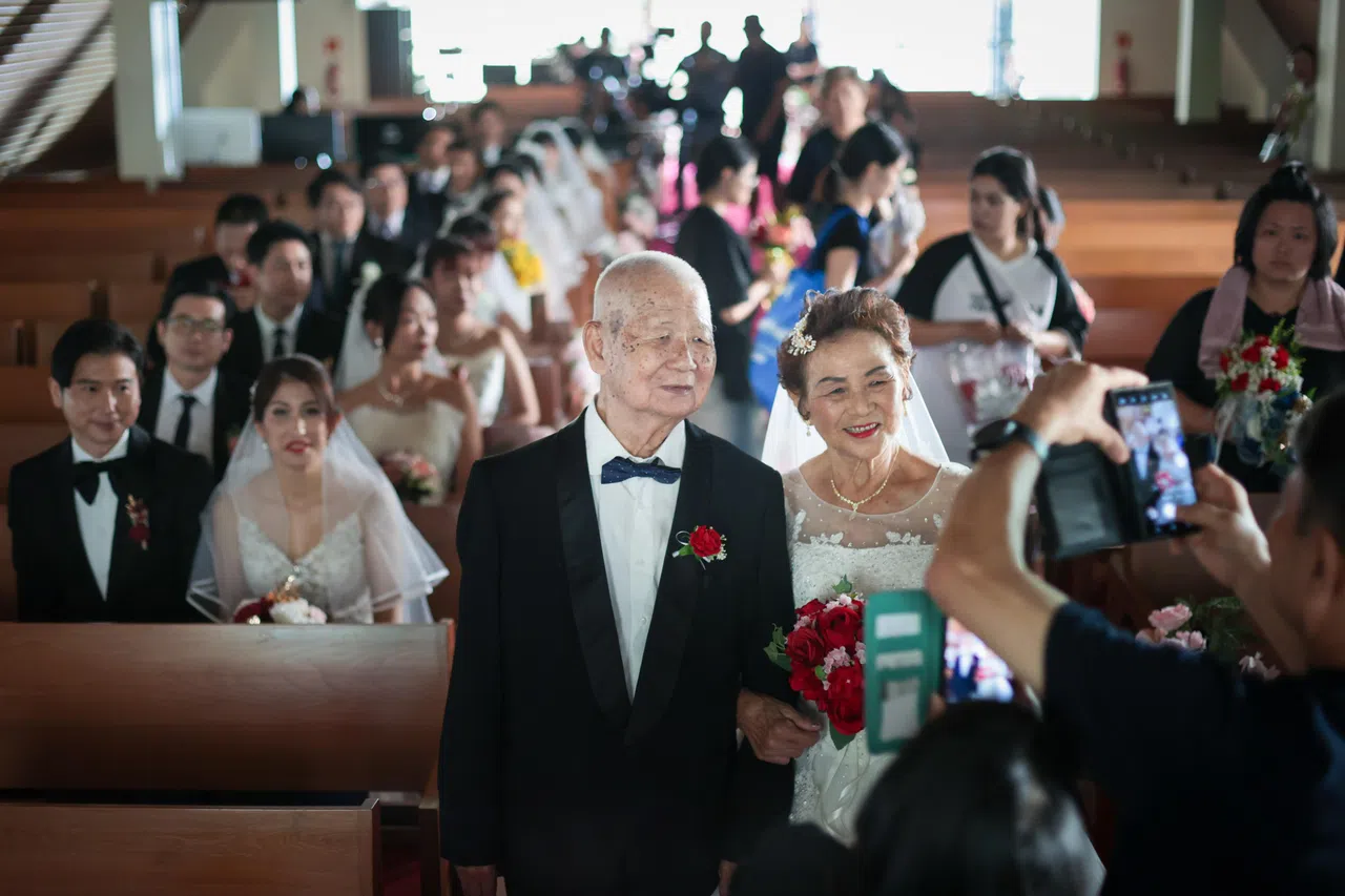 片场有另外30对饰演夫妻的临演，当中有真夫妻，包括梁父梁母。（张俊杰摄）