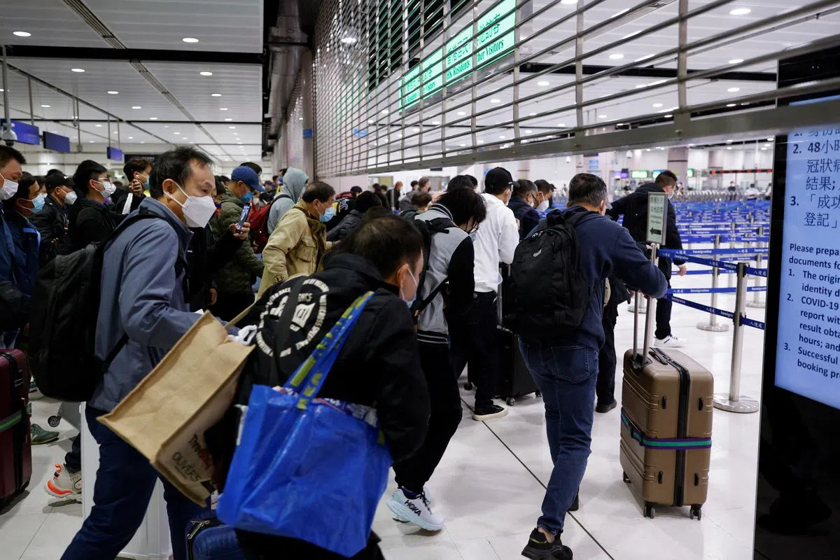 中国大陆和香港在星期天（1月8日）通关，位于香港落马洲的口岸铁栅早上还没完全拉上，大批民众便迫不及待地进入。（路透社）