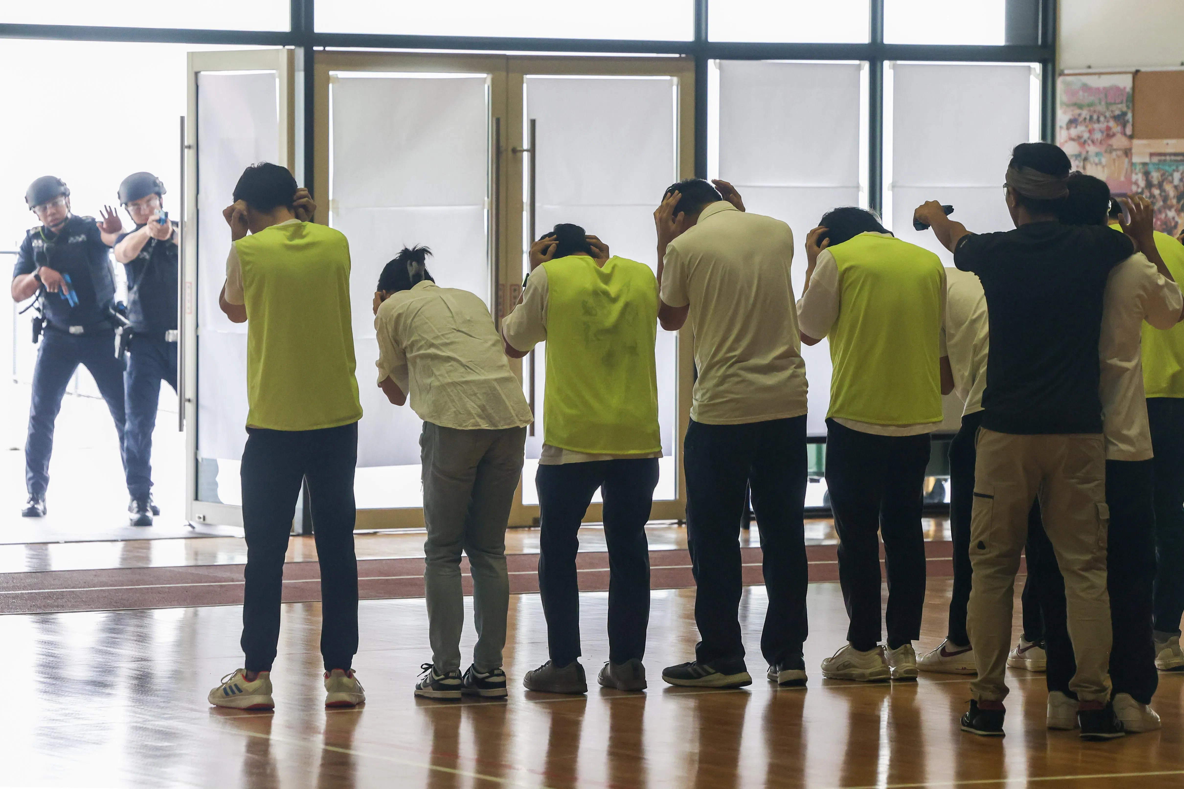 在演习中，“恐怖分子”在体育馆内挟持学生，与警方展开对峙。（陈斌勤摄）