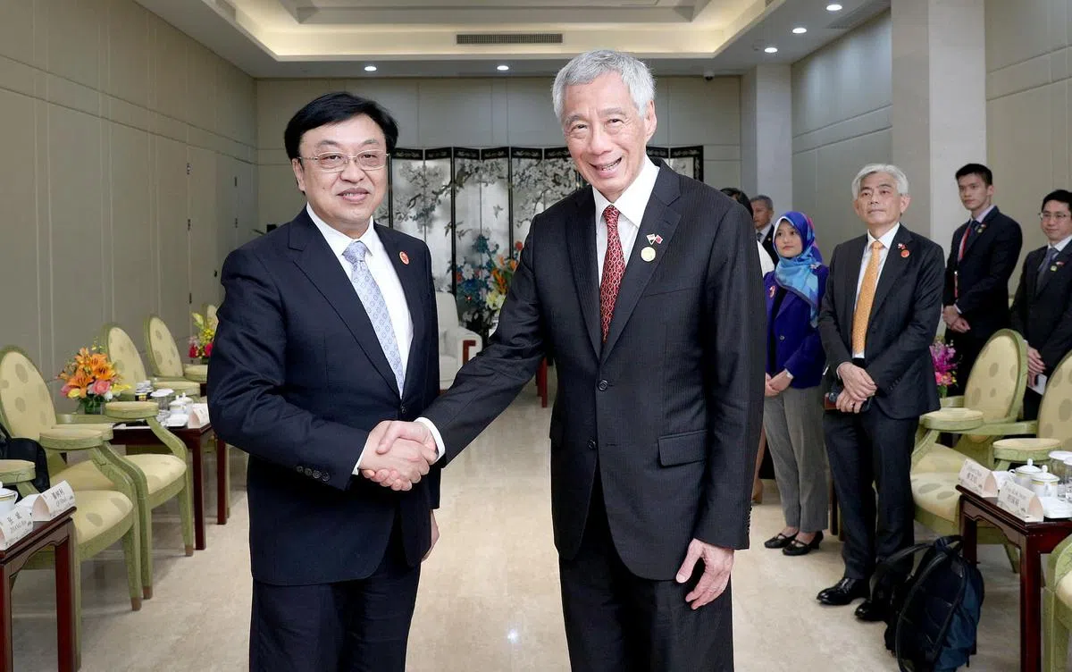 李显龙总理（右）星期四（3月30日）在海南与中共海南省委书记冯飞会面。（通讯及新闻部提供）