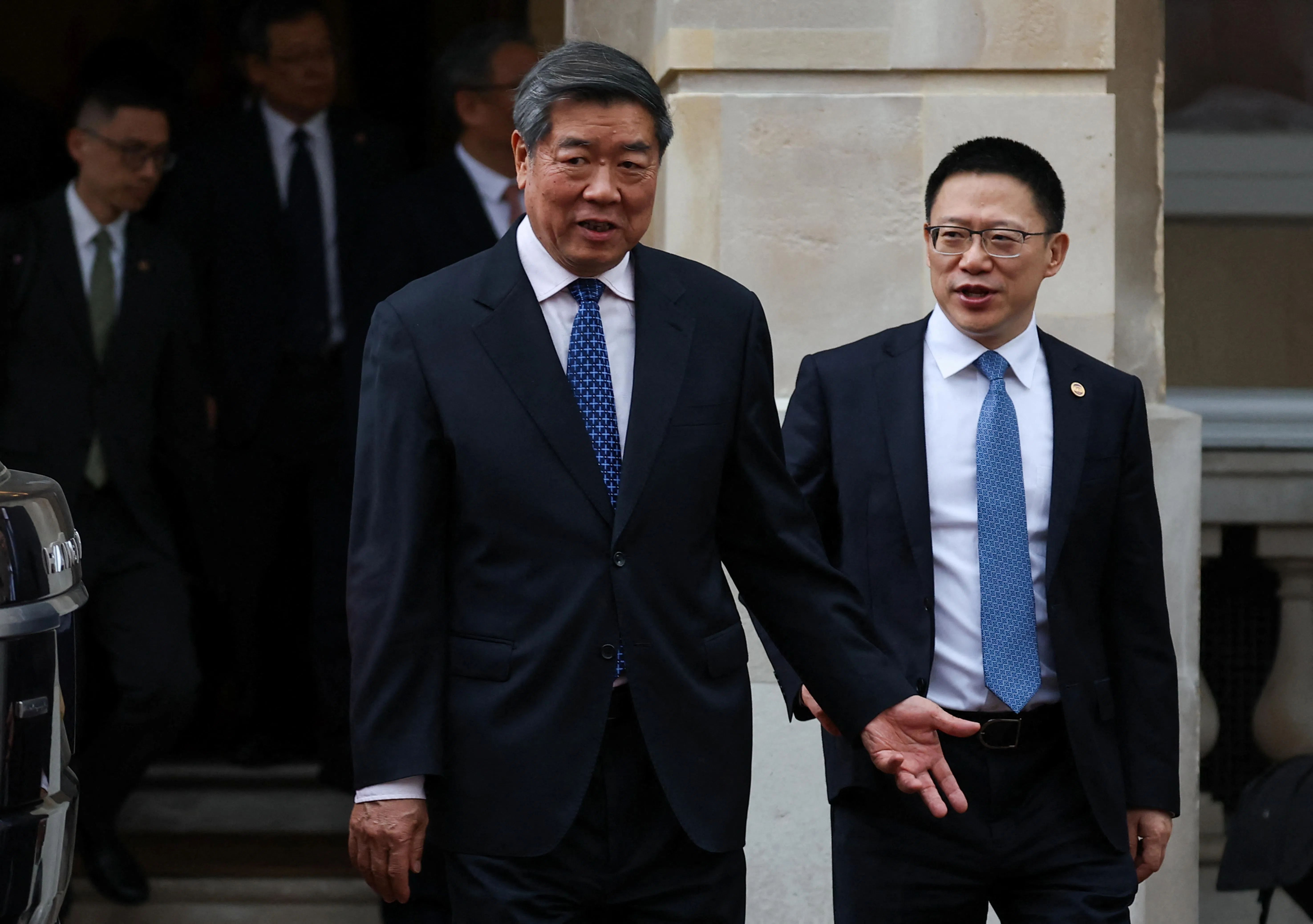 中国副总理何立峰（左）从兰开斯特府离开。（路透社）