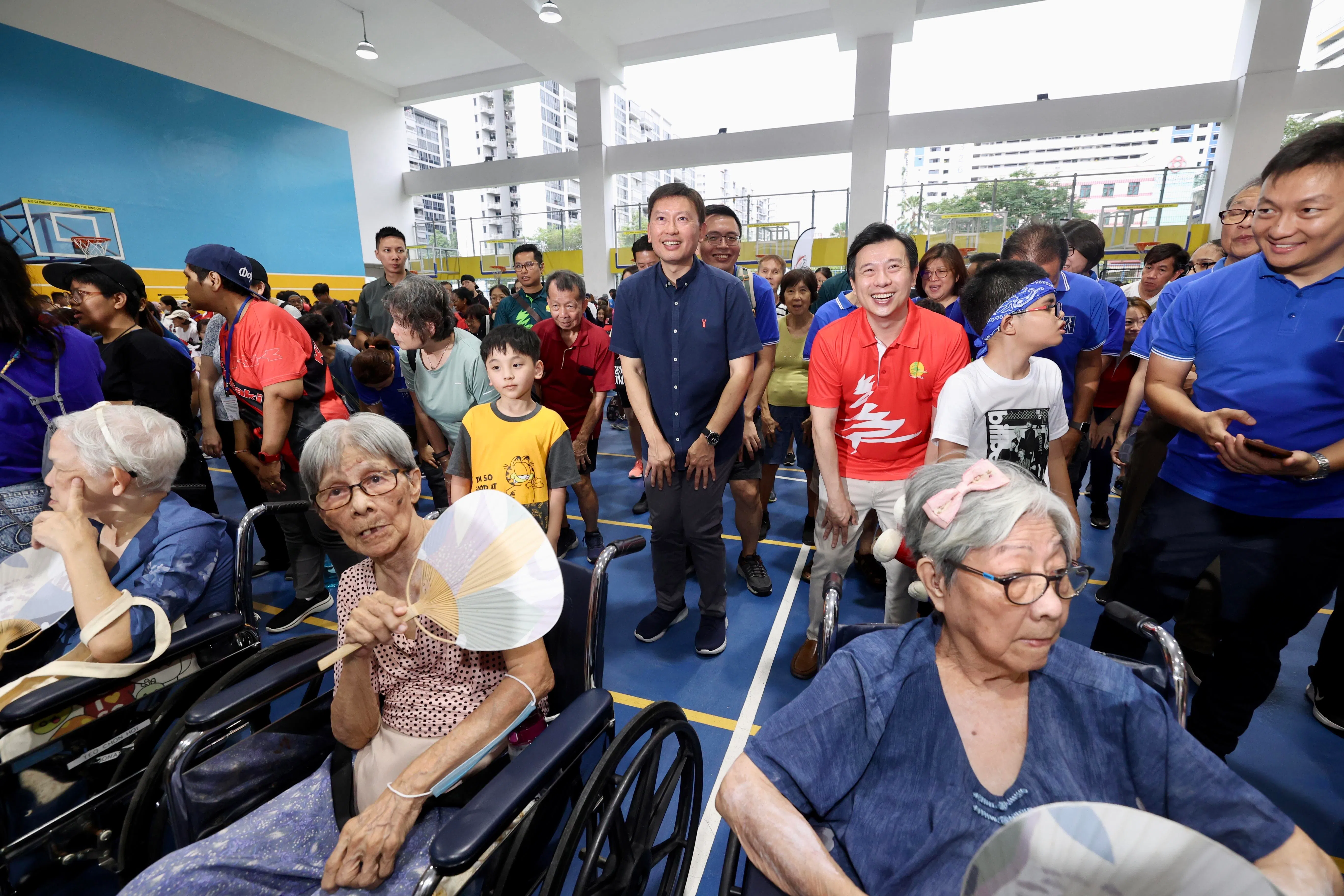 国家发展部长徐芳达（站立者右四）星期六也出席坎贝拉日，他宣布包括坎贝拉在内的一些组屋区将迎来新一轮翻新。他和蓝延理（站立者右三）一同和居民在义走前热身。（邝启聪摄）