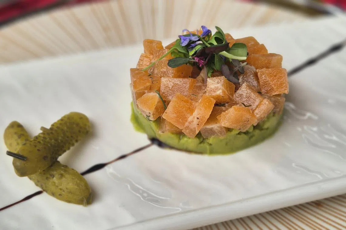 植物性三文鱼丁佐以柚子芥末酱，底层是牛油果泥。（陈爱薇摄）