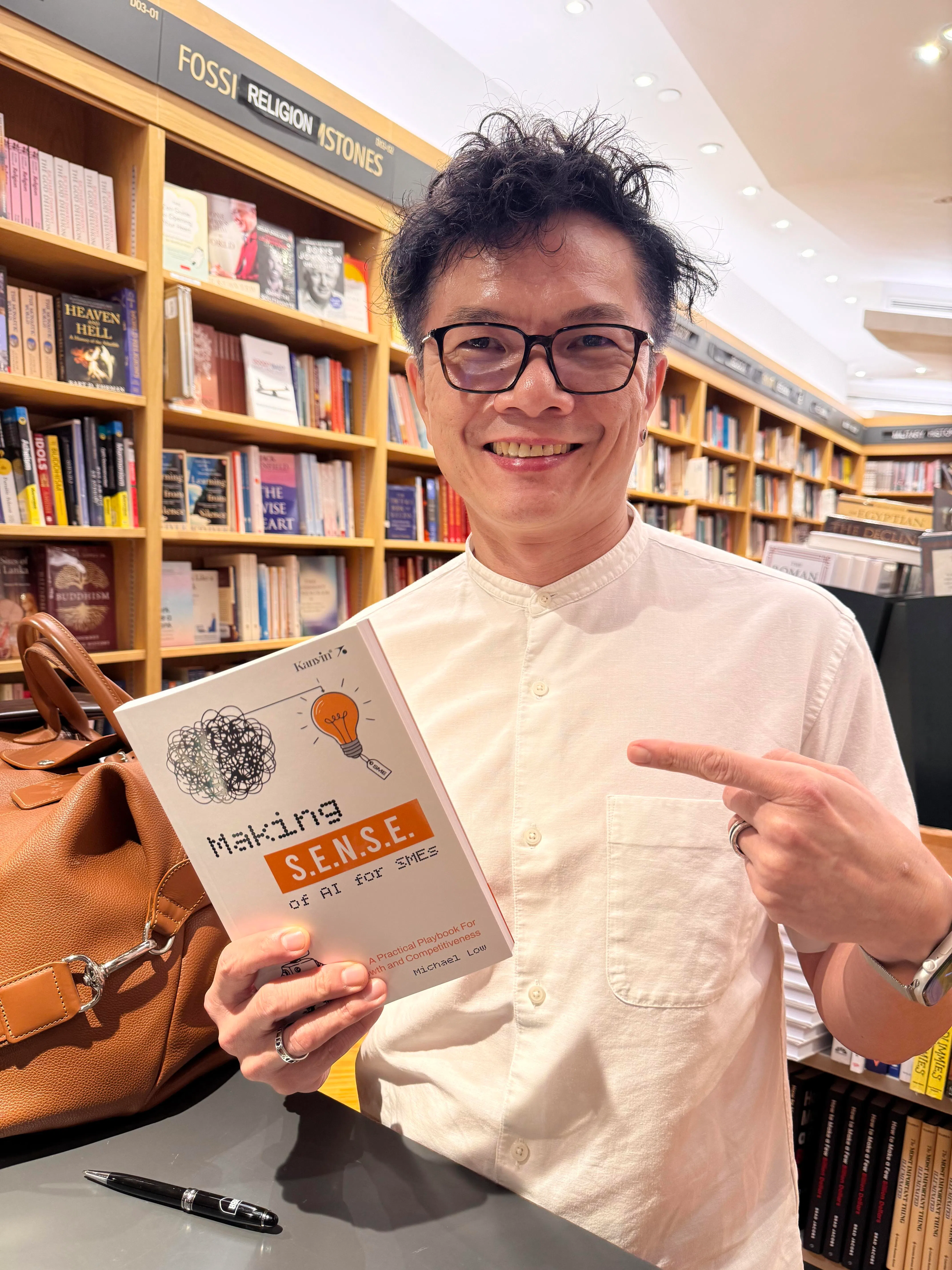 刘光明去年针对中小型企业撰写一本实用手册，为他们踏上AI转型路提供切实建议。图为他在书店举行手册发布会。（受访者提供）