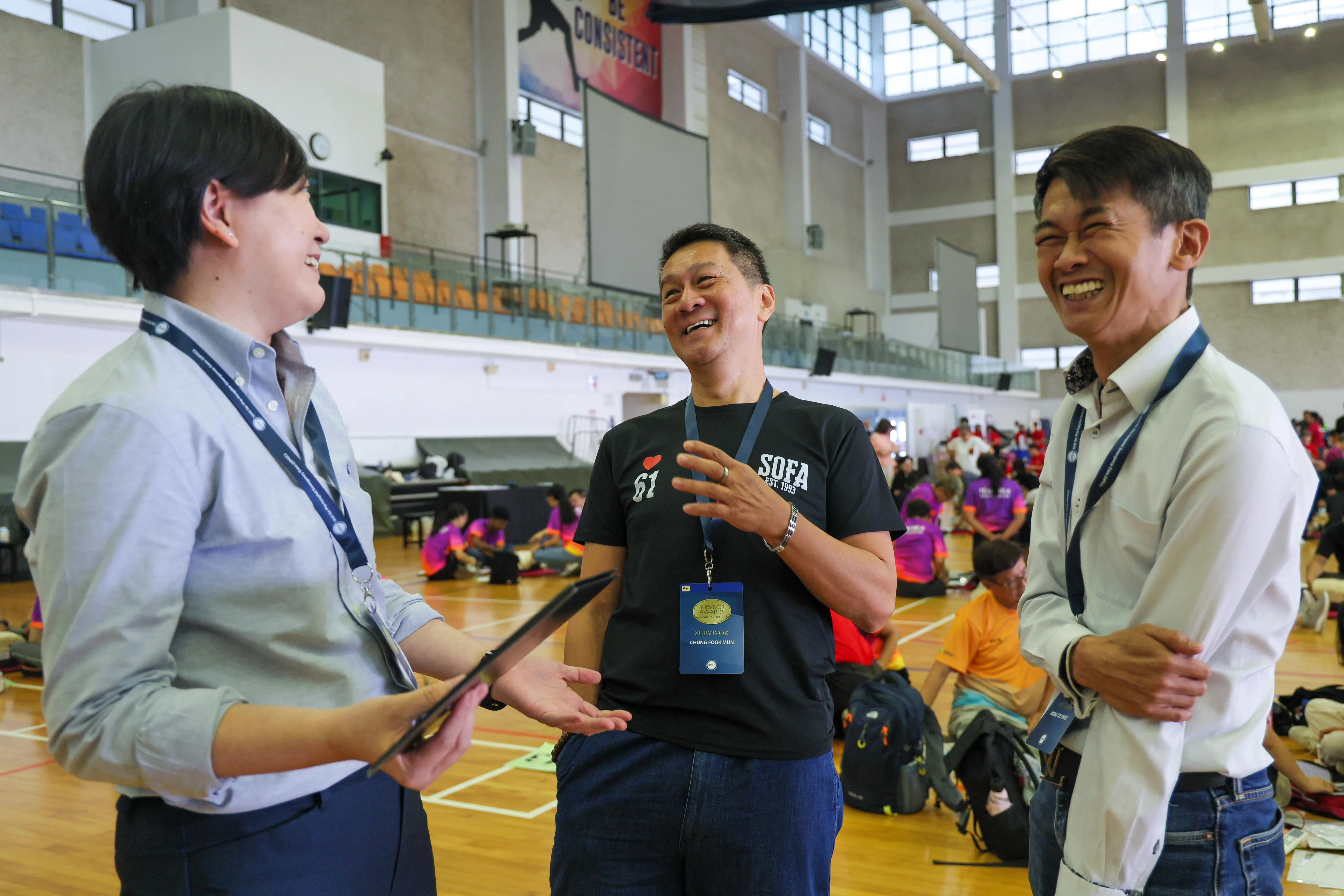 心脏骤停后及时获救的钟福文（中）星期六在“心脏工程”活动上见到了用心肺复苏术救了自己一命的兽医院的医疗人员邓巧仪（左）和黄志辉（右），向他们表达了感谢。（张俊杰摄）