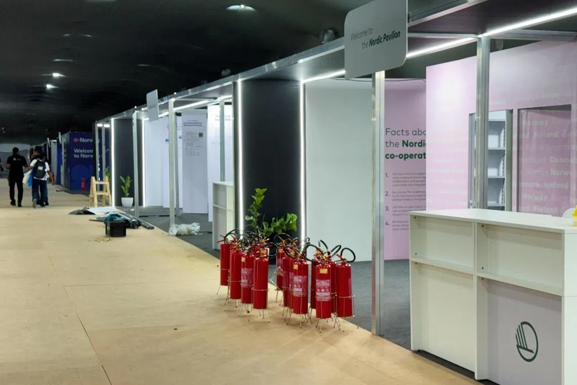 贝伦时间星期一早上8时，COP30场内的一些展馆还没布置完成，馆外可见灭火器还摆在地上。（蔡玮谦摄）