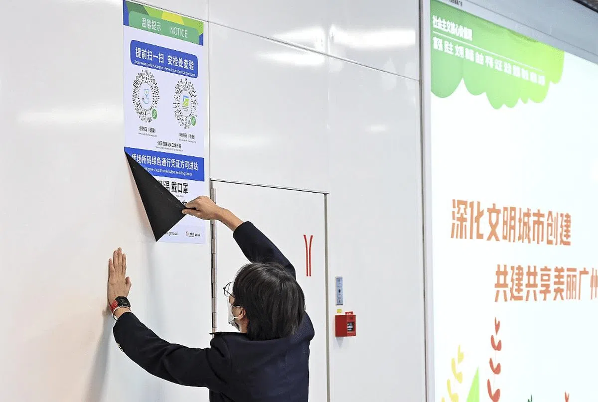 12月7日晚，广州地铁体育西站的工作人员撕掉站内健康码扫码指引。（互联网）