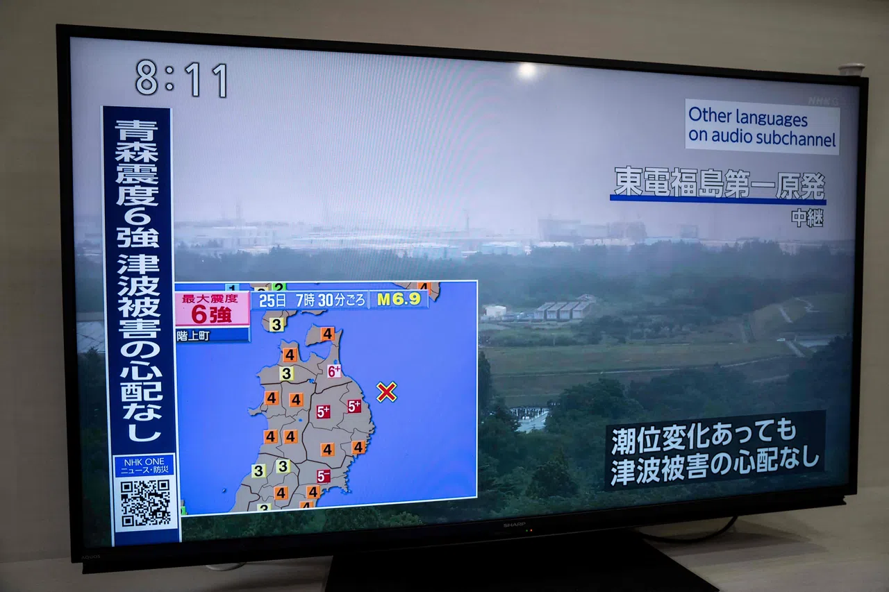 6月25日，神奈川县川崎市一电视屏幕上显示福岛第一核电站的实时画面，并附上警示信息，指青森县发生强烈震动，但无海啸风险。（法新社）