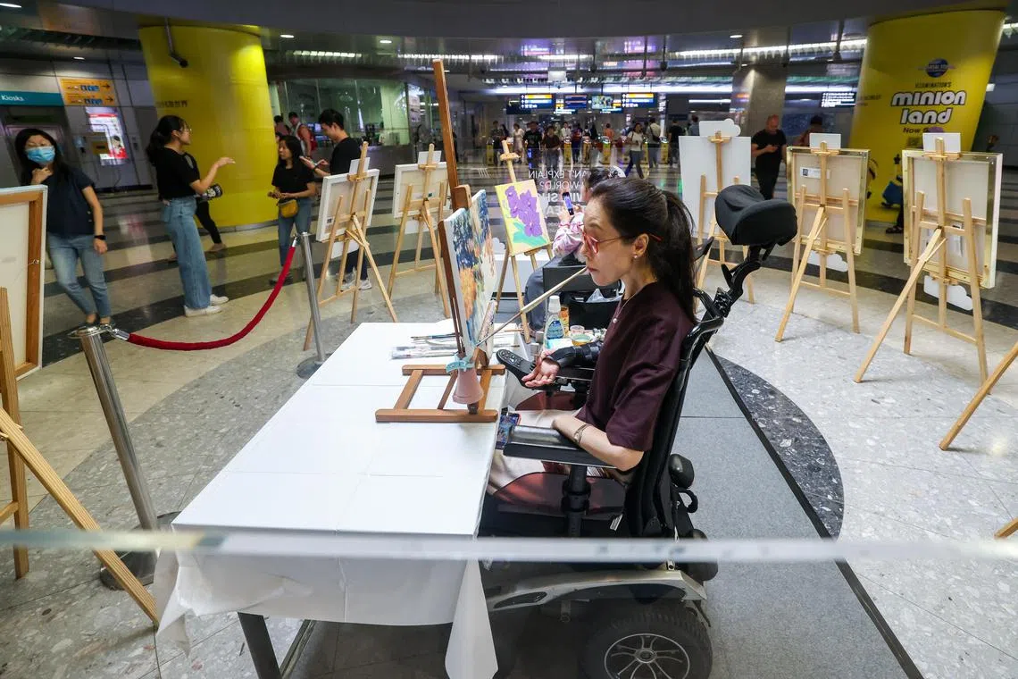 配合巡回展，一些地铁站同期将举办活动，包括邀请特需艺术家现场作画。口足绘画协会画家张凯妮是其中一员，她星期六在海湾舫地铁站现场展现才艺。（陈斌勤摄）