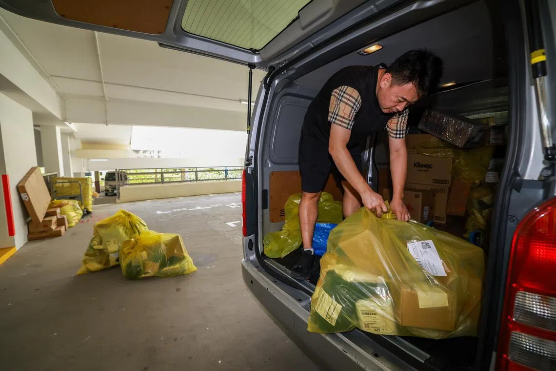 包裹多的时候，马长城一天得来回物流集散中心和各住宅区的10多个停车场9趟，才能在限定的时间内派送完近2000个包裹。（陈斌勤摄）