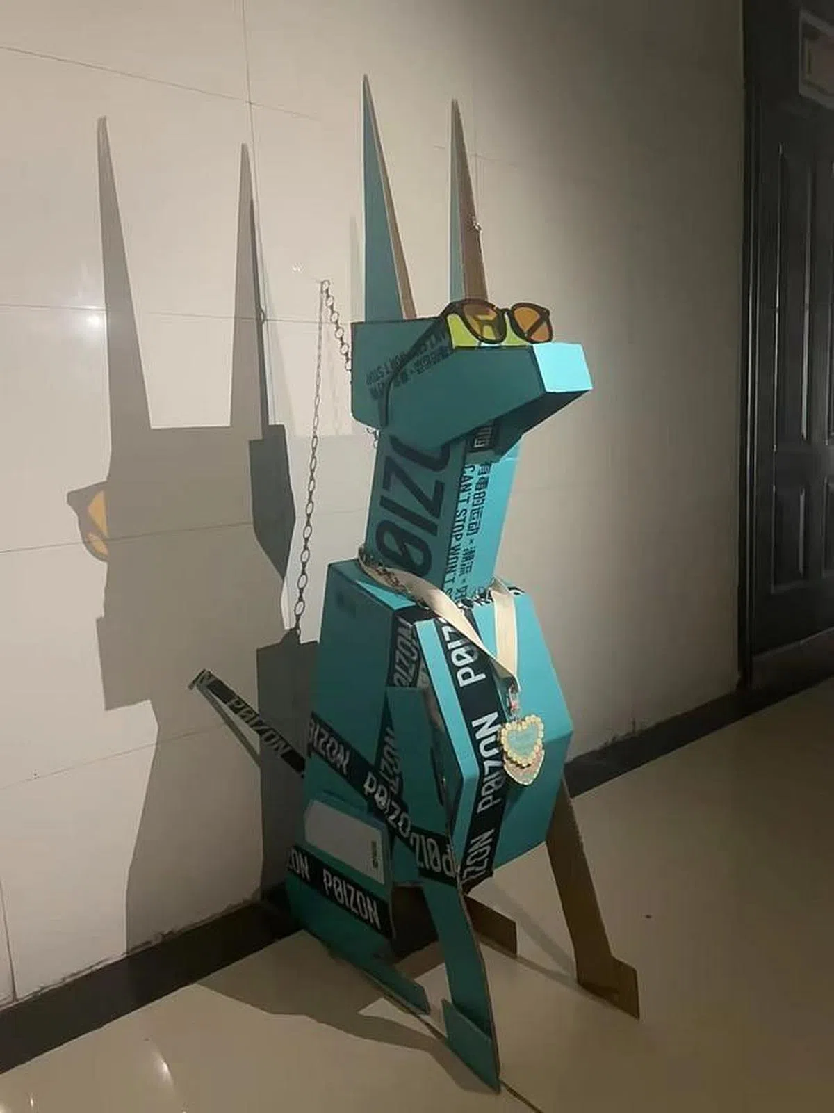 由于制造材料和水平的不同，纸盒狗们有着各式各样的形态和造型。图为一只神似杜宾的帅气纸盒狗。（互联网）