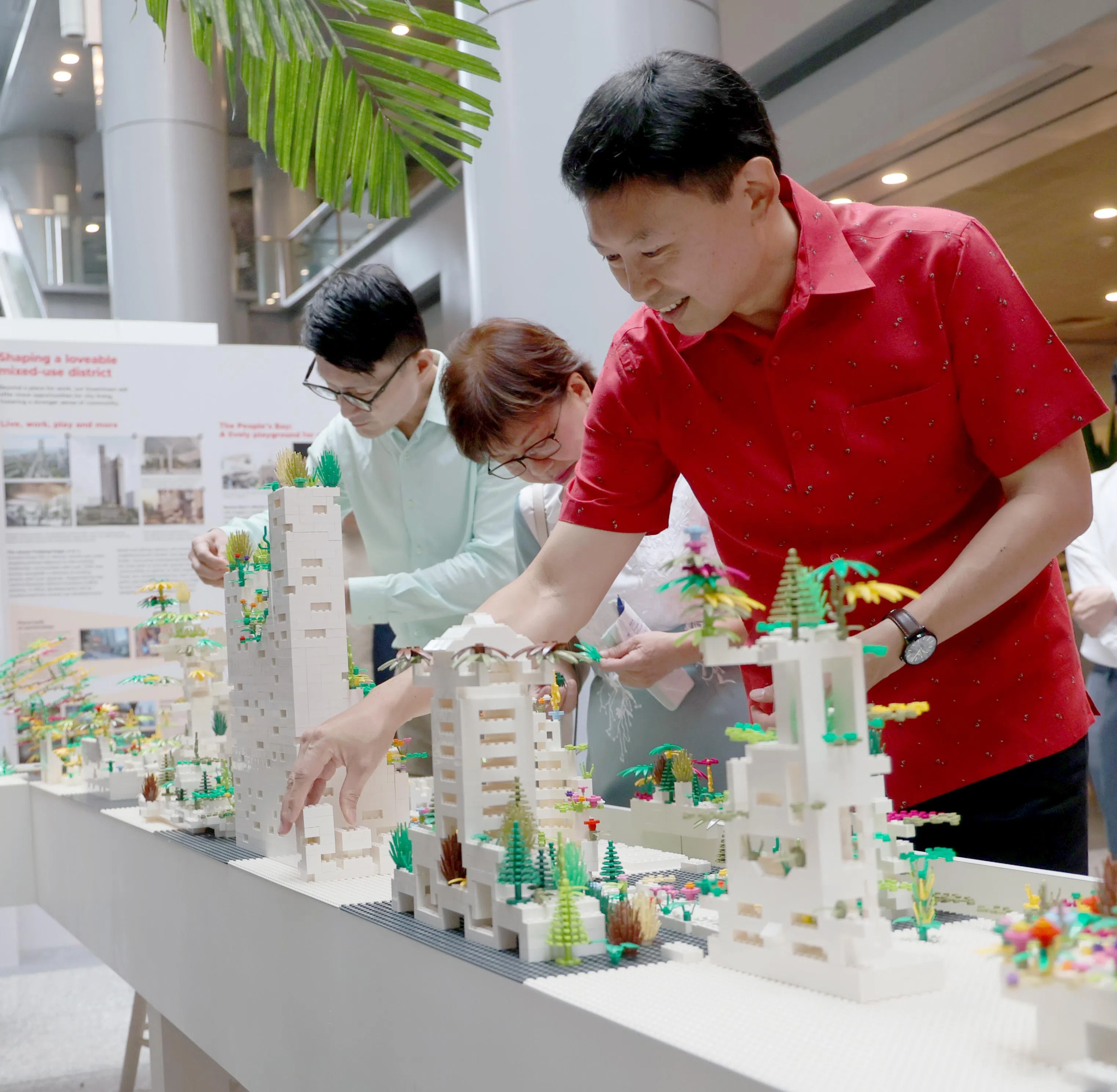 国家发展部长徐芳达星期四（6月26日）在脸书宣布，碧山增设的小贩中心和综合诊疗所等设施，相关工程将在五年内动工，预计需数年完成。图为他星期三（25日）主持《2025年发展总蓝图》草案推介仪式，并在现场与展示互动。（张俊杰摄）